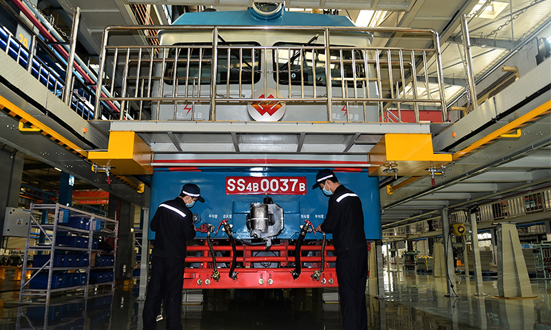 國家能源集團鐵路裝備公司滄州分公司擔負西煤東運第二大通道朔黃鐵路的機車大修任務，這里被形象地稱為“火車醫院”。圖為檢修車間工人進行機車外重聯安裝。（新華社記者 王民 攝）