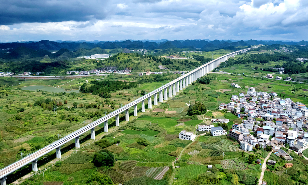 據悉，貴南高鐵是我國《中長期鐵路網規劃》“八縱八橫”高速鐵路網包海通道的重要組成部分，也是銜接“一帶一路”陸路南北新通道的關鍵線路。貴南高鐵貴陽至荔波段開通運營后，貴陽至荔波最快57分鐘可達，對于改善沿線群眾出行條件、優化黔桂兩省(區)旅游黃金通道、促進沿線鄉村振興和經濟社會高質量發展具有重要意義。圖為8月7日，試驗動車組通過貴南高鐵貴陽至荔波段拉里雙線特大橋。