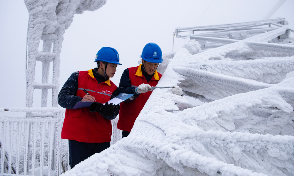 國家電網紅巖（重慶城口）共產黨員服務隊在觀冰點測量220千伏華城線模擬導線覆冰厚度。