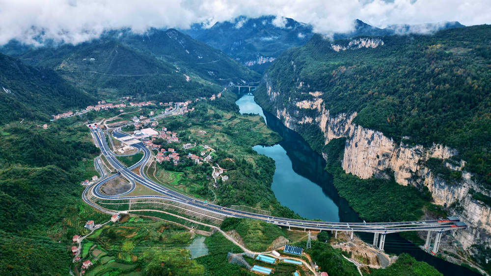 阿蓬江大橋不僅橫跨雄奇秀美的阿蓬江，一端還連接著穿越“90度懸崖峭壁”的龔灘隧道。隧道出口陡崖風(fēng)化、溶蝕嚴(yán)重，施工既存在危巖落石隱患，又容易導(dǎo)致施工污染。為此，建設(shè)者創(chuàng)新設(shè)計了8級陡崖加固方案，不僅克服了坡腳地質(zhì)不穩(wěn)、受力復(fù)雜等難題，還顯著降低了廢棄物對烏江可能造成的污染，有力守護(hù)了區(qū)域的綠水青山。圖為渝湘復(fù)線高速阿蓬江大橋。