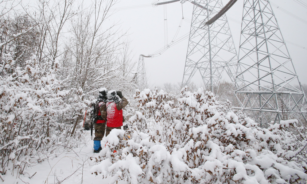 近日，受蛇年首場寒潮影響，我國中東部地區氣溫持續走低，局地氣溫下降10攝氏度以上。國家電網有限公司堅決扛牢電力保供首要責任，加強對重要變電站、線路及供暖設施的巡檢特護和運行監控，全力保障電網安全運行和電力可靠供應，用心守護人民群眾溫暖度冬。圖為國家電網遼寧本溪供電公司工作人員對500千伏豐徐線“三跨”重要區段開展特巡特護。